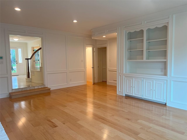 13631 Balmore Cir, Houston, TX 77069 - unfurnished room featuring a decorative wall, light wood-type flooring, stairway, recessed lighting, and ornamental molding
