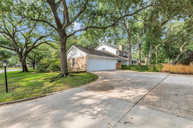 13631 Balmore Cir, Houston, TX 77069 - view of side of home with concrete driveway, a garage, and brick siding