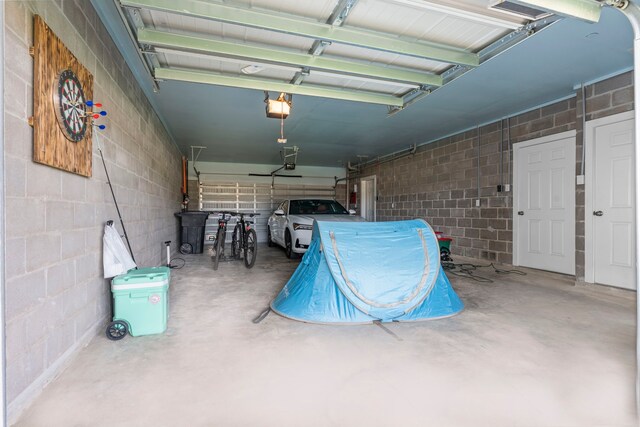 1304 Veranda Mist, League City, TX 77573 - garage featuring a garage door opener and concrete block wall