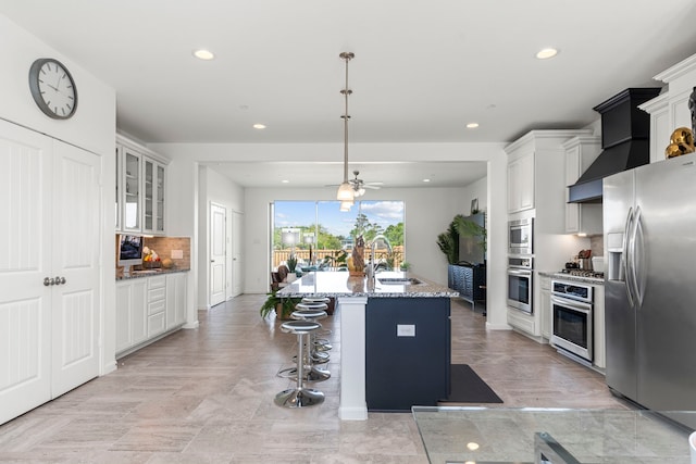 1304 Veranda Mist, League City, TX 77573 - kitchen featuring appliances with stainless steel finishes, a sink, light stone countertops, backsplash, and recessed lighting