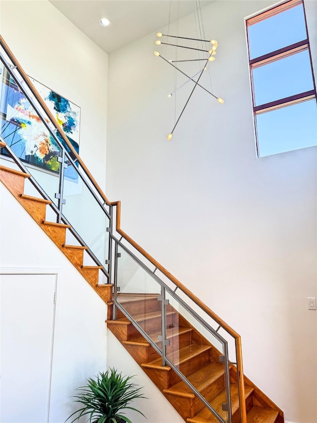 8003 Harbor Point Dr, Houston, TX 77071 - stairway with a high ceiling, a chandelier, and recessed lighting