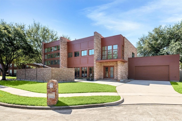 8003 Harbor Point Dr, Houston, TX 77071 - contemporary home featuring french doors, concrete driveway, a front yard, a garage, and brick siding