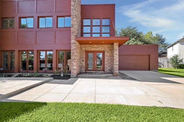 8003 Harbor Point Dr, Houston, TX 77071 - view of exterior entry featuring french doors, brick siding, and a garage