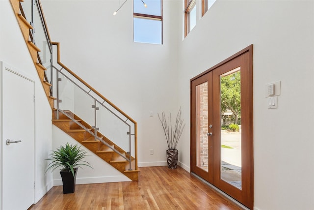 8003 Harbor Point Dr, Houston, TX 77071 - entryway with stairs, wood finished floors, a high ceiling, and baseboards