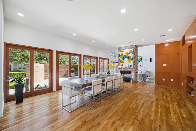 8003 Harbor Point Dr, Houston, TX 77071 - dining area with light wood-type flooring, recessed lighting, and a stone fireplace