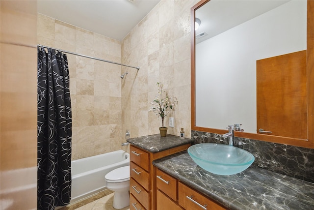 8003 Harbor Point Dr, Houston, TX 77071 - full bathroom featuring vanity, shower / bath combo, toilet, tile patterned floors, and tile walls