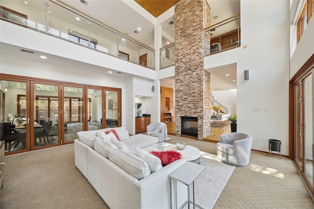 8003 Harbor Point Dr, Houston, TX 77071 - living room featuring a towering ceiling, carpet, a brick fireplace, french doors, and recessed lighting