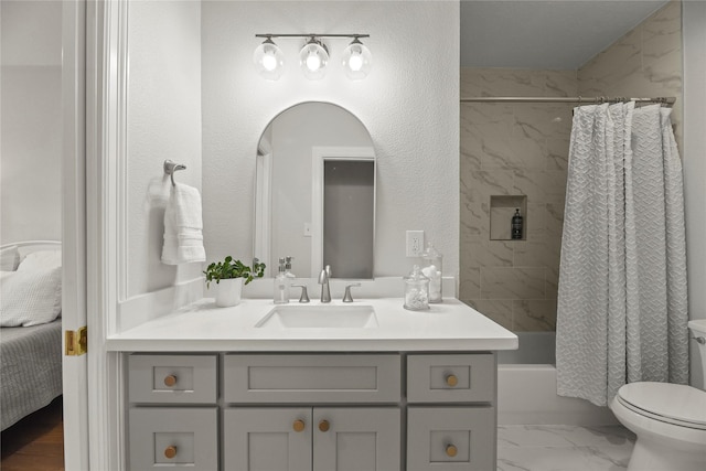 18818 Cypress Chateau Dr, Spring, TX 77388 - ensuite bathroom with vanity, marble look tiles, toilet, and shower / bath combo