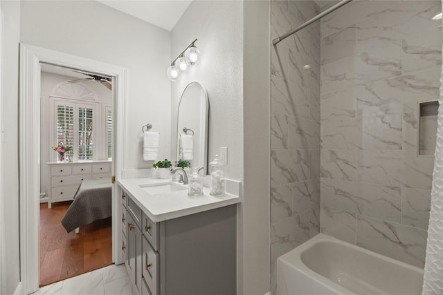 18818 Cypress Chateau Dr, Spring, TX 77388 - bathroom with vanity,  shower combination, ceiling fan, and marble look tiles