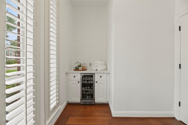 18818 Cypress Chateau Dr, Spring, TX 77388 - indoor dry bar with beverage cooler, dark wood-style floors, and baseboards