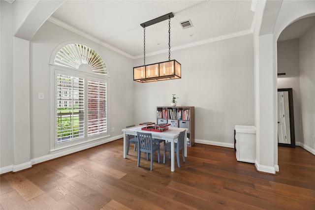 18818 Cypress Chateau Dr, Spring, TX 77388 - dining space featuring arched walkways, wood finished floors, baseboards, and crown molding