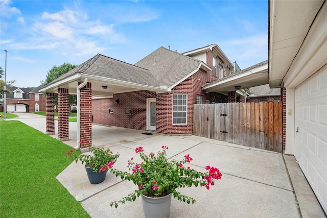 18818 Cypress Chateau Dr, Spring, TX 77388 - view of property exterior with brick siding, a shingled roof, driveway, and a garage