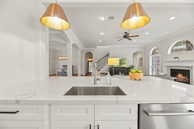 18818 Cypress Chateau Dr, Spring, TX 77388 - kitchen featuring open floor plan, stainless steel dishwasher, arched walkways, a sink, and ornamental molding