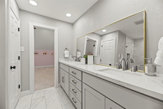 18818 Cypress Chateau Dr, Spring, TX 77388 - bathroom featuring double vanity, a tile shower, recessed lighting, marble finish flooring, and baseboards