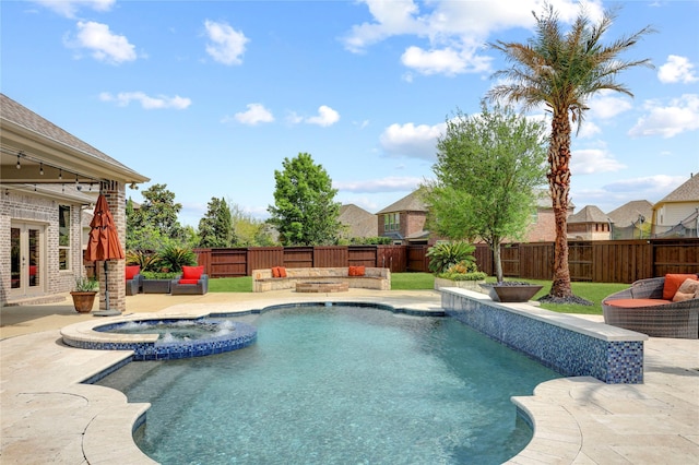 10727 Stone Isle Ct, Richmond, TX 77407 - view of swimming pool with french doors, a patio area, a fenced backyard, and a pool with connected hot tub