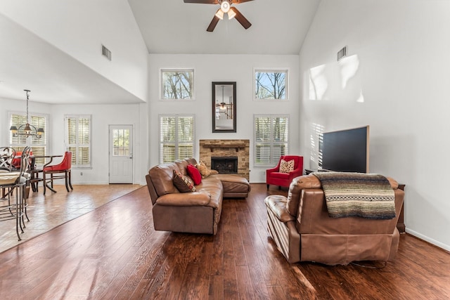 11 Snow Woods Ct, The Woodlands, TX 77385 - living room with high vaulted ceiling, ceiling fan, a stone fireplace, baseboards, and wood finished floors