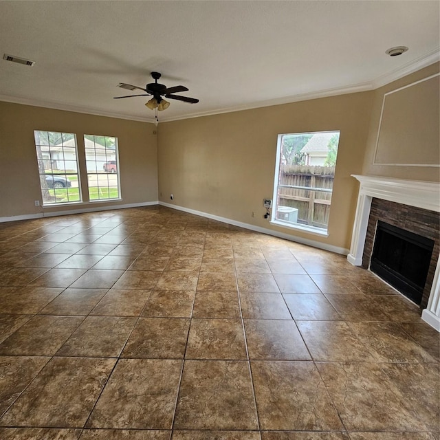 6118 Deep S Dr, Katy, TX 77449 - unfurnished living room featuring healthy amount of natural light, crown molding, a fireplace, ceiling fan, and baseboards