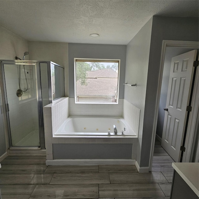6118 Deep S Dr, Katy, TX 77449 - full bath featuring a jetted tub, a stall shower, a textured ceiling, vanity, and baseboards