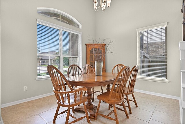 2708 Merlin Ln, Pearland, TX 77581 - dining space with a chandelier, light tile patterned floors, baseboards, and a high ceiling