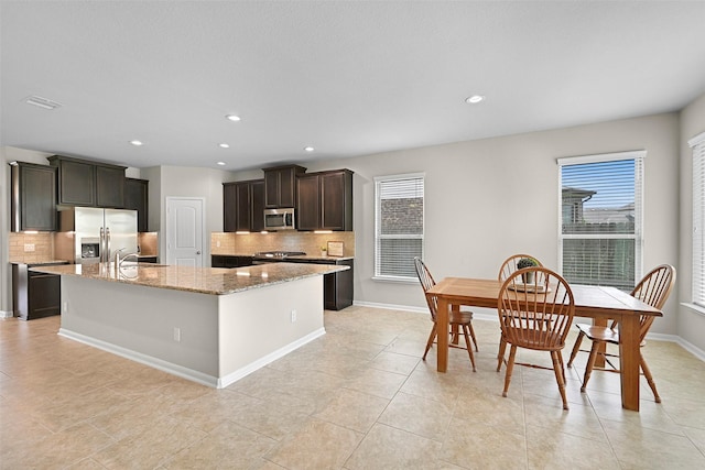 2708 Merlin Ln, Pearland, TX 77581 - kitchen featuring appliances with stainless steel finishes, backsplash, healthy amount of natural light, and recessed lighting