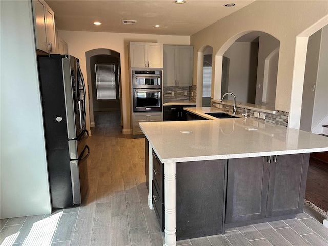24811 Deep Coral Ct, Katy, TX 77494 - kitchen featuring stainless steel appliances, a sink, light wood-type flooring, decorative backsplash, and recessed lighting