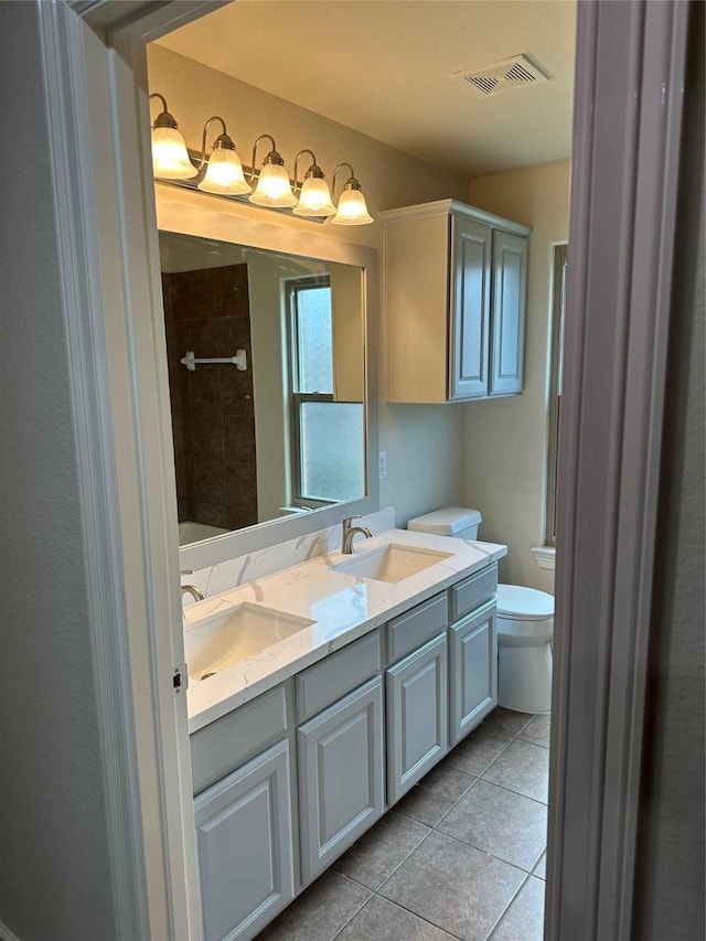 24811 Deep Coral Ct, Katy, TX 77494 - full bathroom featuring double vanity, toilet, tile patterned floors, and tiled shower