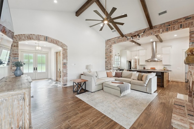 9343 Kai Dr, Beach City, TX 77523 - living room with high vaulted ceiling, beamed ceiling, ceiling fan, arched walkways, and wood finished floors
