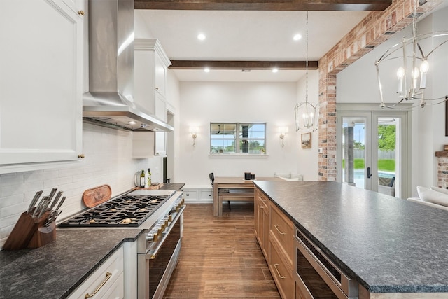9343 Kai Dr, Beach City, TX 77523 - kitchen featuring wall chimney range hood, appliances with stainless steel finishes, a chandelier, dark wood-style flooring, and beam ceiling