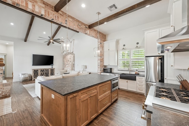 9343 Kai Dr, Beach City, TX 77523 - kitchen featuring a sink, stainless steel appliances, beam ceiling, dark wood-type flooring, and white cabinetry