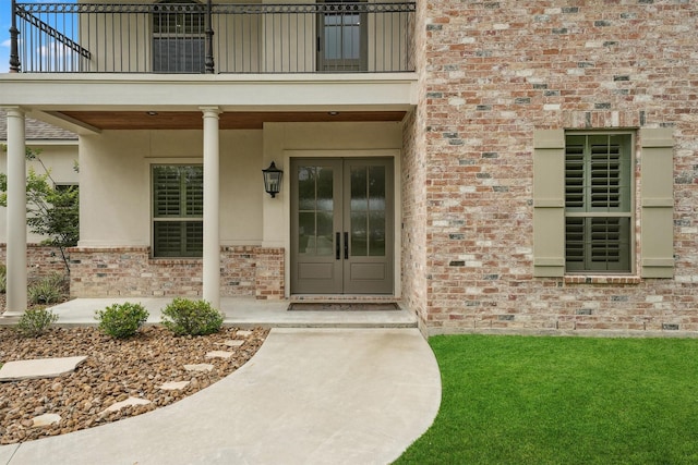 9343 Kai Dr, Beach City, TX 77523 - property entrance with a balcony, french doors, brick siding, and stucco siding