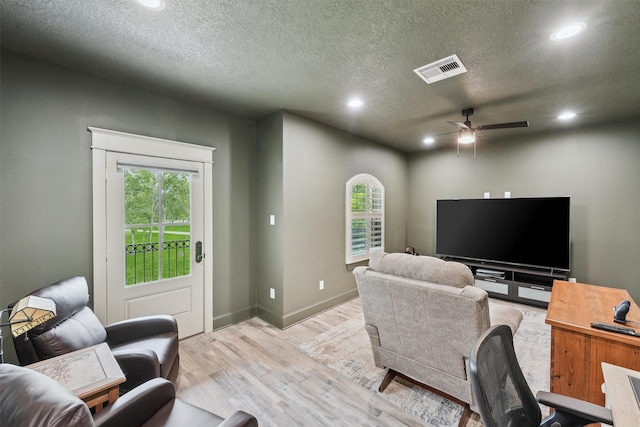 9343 Kai Dr, Beach City, TX 77523 - living room with recessed lighting, healthy amount of natural light, ceiling fan, light wood-type flooring, and a textured ceiling