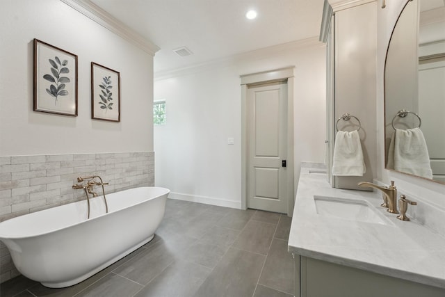 9343 Kai Dr, Beach City, TX 77523 - bathroom featuring double vanity, ornamental molding, a freestanding bath, tile walls, and recessed lighting