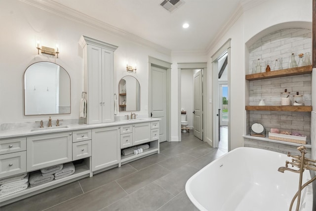 9343 Kai Dr, Beach City, TX 77523 - bathroom with double vanity, a freestanding bath, toilet, crown molding, and tile patterned floors