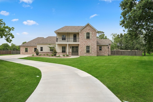 9343 Kai Dr, Beach City, TX 77523 - back of property with french doors, a balcony, stucco siding, brick siding, and a shingled roof