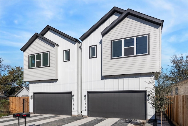 1201 E 27th St, Houston, TX 77009 - modern farmhouse featuring board and batten siding, an attached garage, and driveway