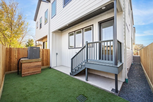 1201 E 27th St, Houston, TX 77009 - rear view of house with board and batten siding and cooling unit