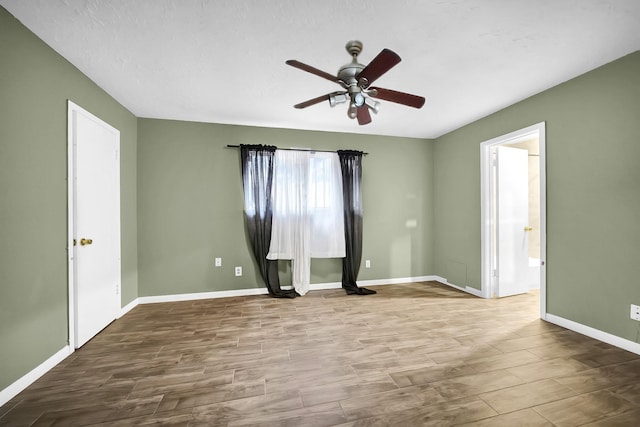 8030 Dodiewood Ln, Houston, TX 77086 - spare room featuring a ceiling fan, baseboards, and wood finished floors