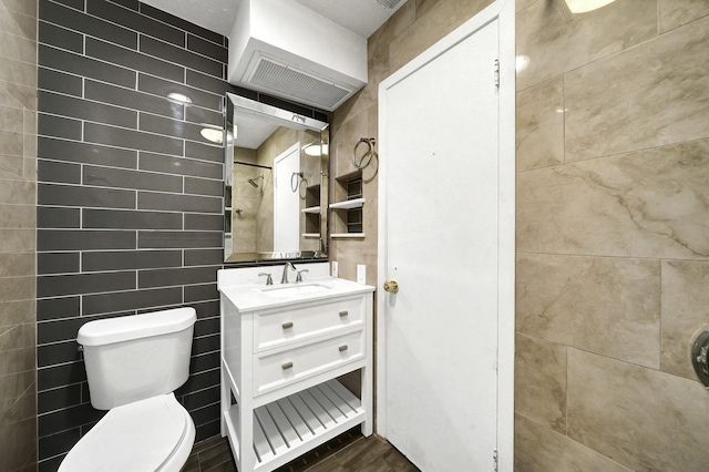 8030 Dodiewood Ln, Houston, TX 77086 - bathroom featuring toilet, vanity, tile walls, and a shower