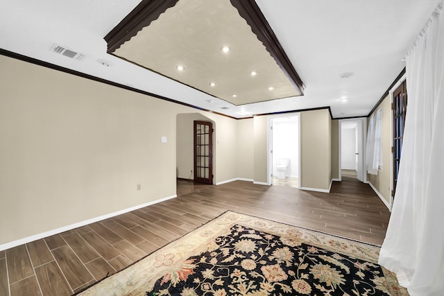 8030 Dodiewood Ln, Houston, TX 77086 - spare room with arched walkways, wood finished floors, crown molding, recessed lighting, and baseboards