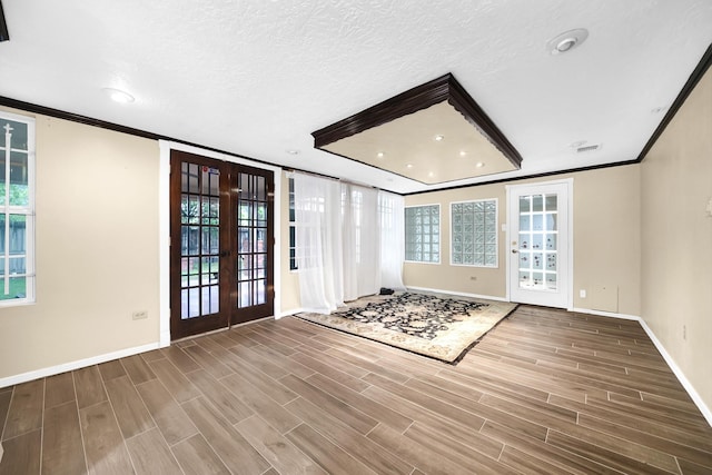 8030 Dodiewood Ln, Houston, TX 77086 - entrance foyer with french doors, baseboards, crown molding, wood finished floors, and healthy amount of natural light