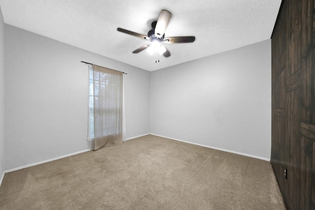 8030 Dodiewood Ln, Houston, TX 77086 - carpeted empty room with ceiling fan, baseboards, and a textured ceiling