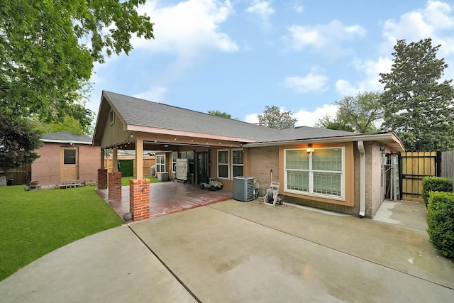 8030 Dodiewood Ln, Houston, TX 77086 - view of front of house featuring a patio area, central AC, a gate, and brick siding