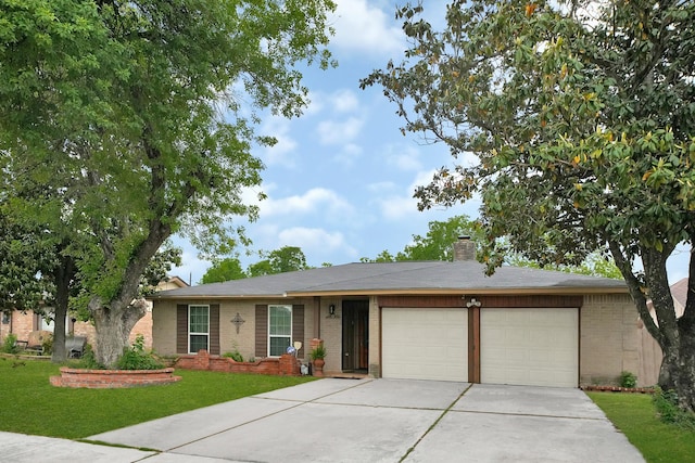 8030 Dodiewood Ln, Houston, TX 77086 - ranch-style home featuring brick siding, a garage, driveway, a front lawn, and a chimney