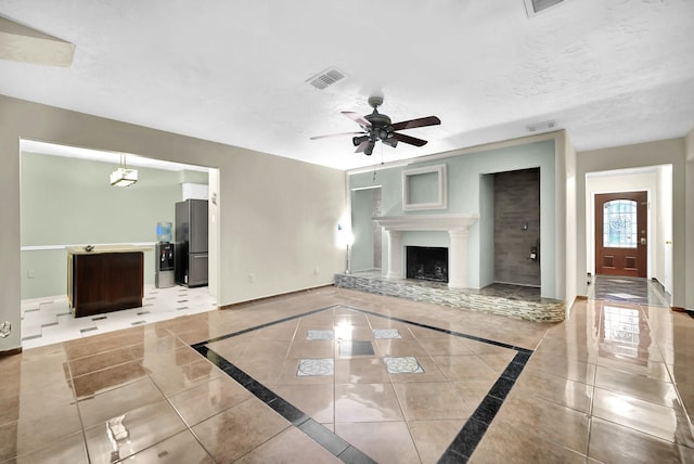 8030 Dodiewood Ln, Houston, TX 77086 - unfurnished living room with baseboards, inlaid floor details, ceiling fan, and light tile patterned floors