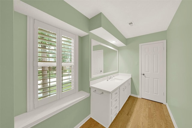 16111 Maplehurst Dr, Houston, TX 77379 - bathroom featuring vanity, wood finished floors, and baseboards