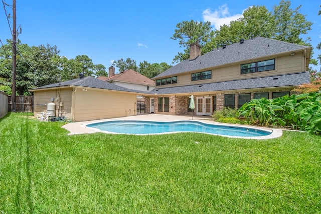 16111 Maplehurst Dr, Houston, TX 77379 - rear view of property with french doors, a chimney, a patio, and brick siding