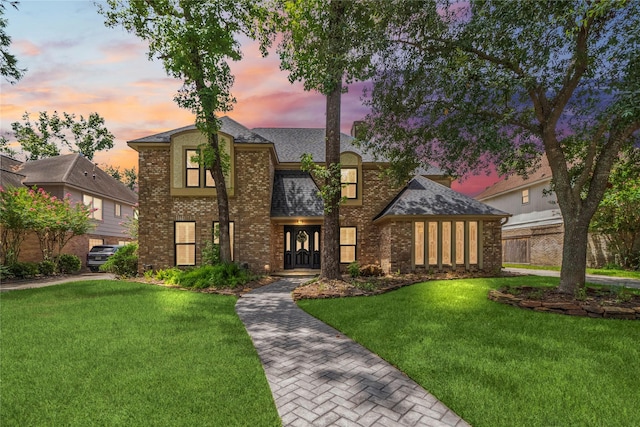 16111 Maplehurst Dr, Houston, TX 77379 - view of front of house with brick siding, a lawn, and roof with shingles