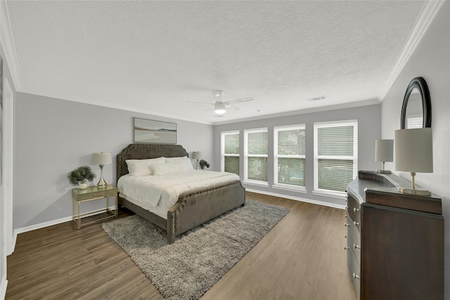 16111 Maplehurst Dr, Houston, TX 77379 - bedroom featuring ornamental molding, multiple windows, wood finished floors, baseboards, and a textured ceiling
