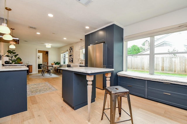 2735 Triway Ln, Houston, TX 77043 - kitchen featuring freestanding refrigerator, light countertops, plenty of natural light, recessed lighting, and light wood-style flooring