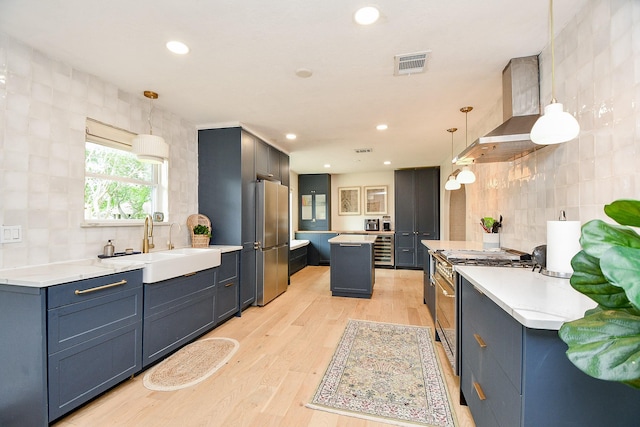 2735 Triway Ln, Houston, TX 77043 - kitchen featuring appliances with stainless steel finishes, a sink, backsplash, light wood finished floors, and recessed lighting
